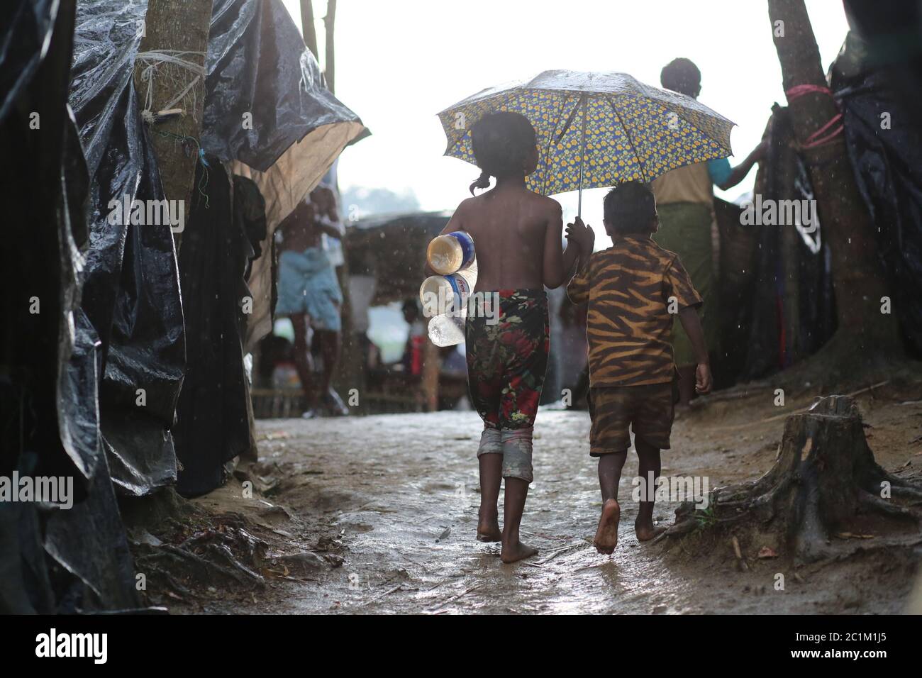 A Rohingya refugee child going to collect drinking water at Kutupalong refugee camp, Bangladesh, Tuesday, Oct. 03, 2017. Stock Photo
