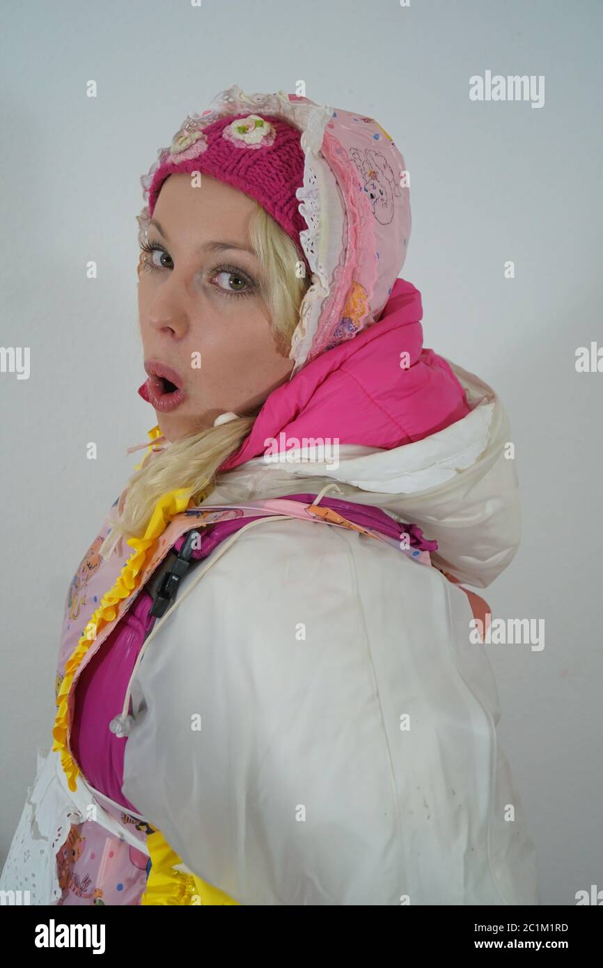 beautiful maid in rainwear, apron, downweaqr and bonnet Stock Photo