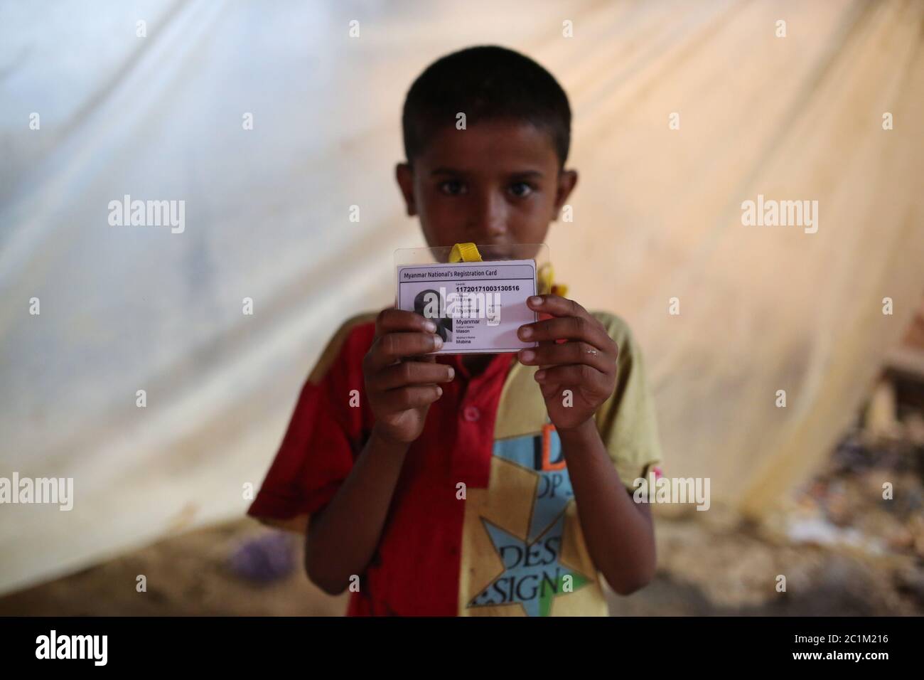 A Rohigya child show his ID card that he collect from Bangladesh at Kutupalong refugee camp, Bangladesh, Tuesday, Oct. 03, 2017. Stock Photo