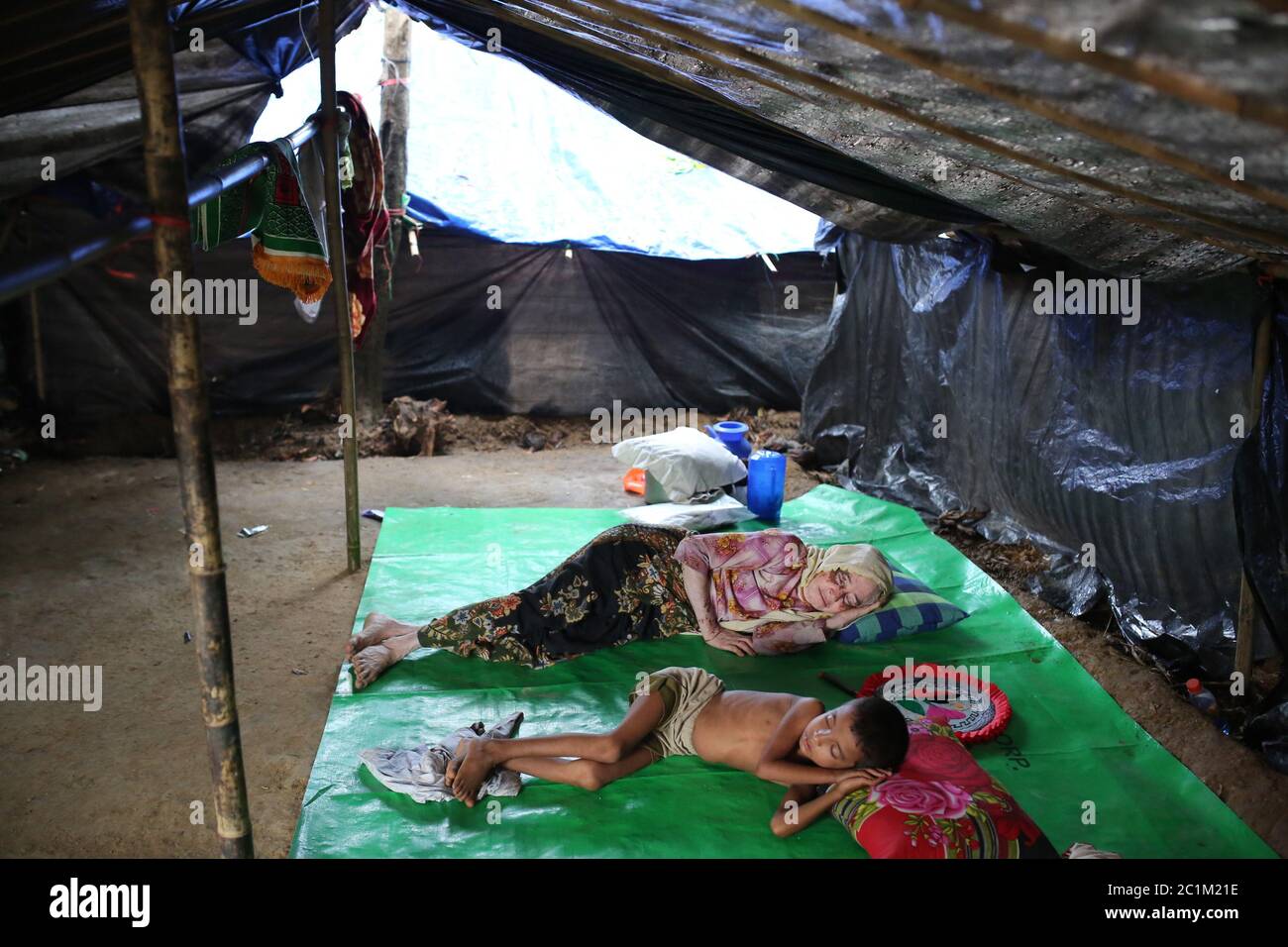 Rohingya people sleep on floor at Kutupalong refugee camp, Bangladesh, Tuesday, Oct. 03, 2017. Stock Photo