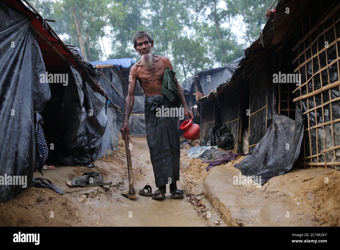 A Rohingya old man walk through camp at Kutupalong refugee camp, Bangladesh, Tuesday, Oct. 03, 2017. Stock Photo