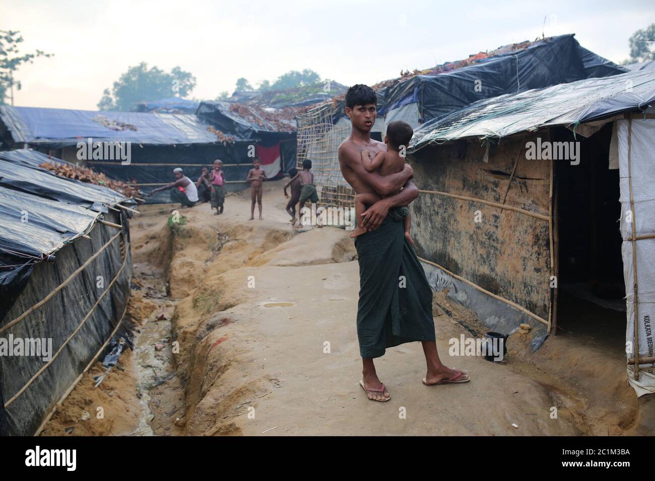 A Rohingya man stand with his son inside camp at Kutupalong refugee camp, Bangladesh, Tuesday, Oct. 03, 2017. Stock Photo