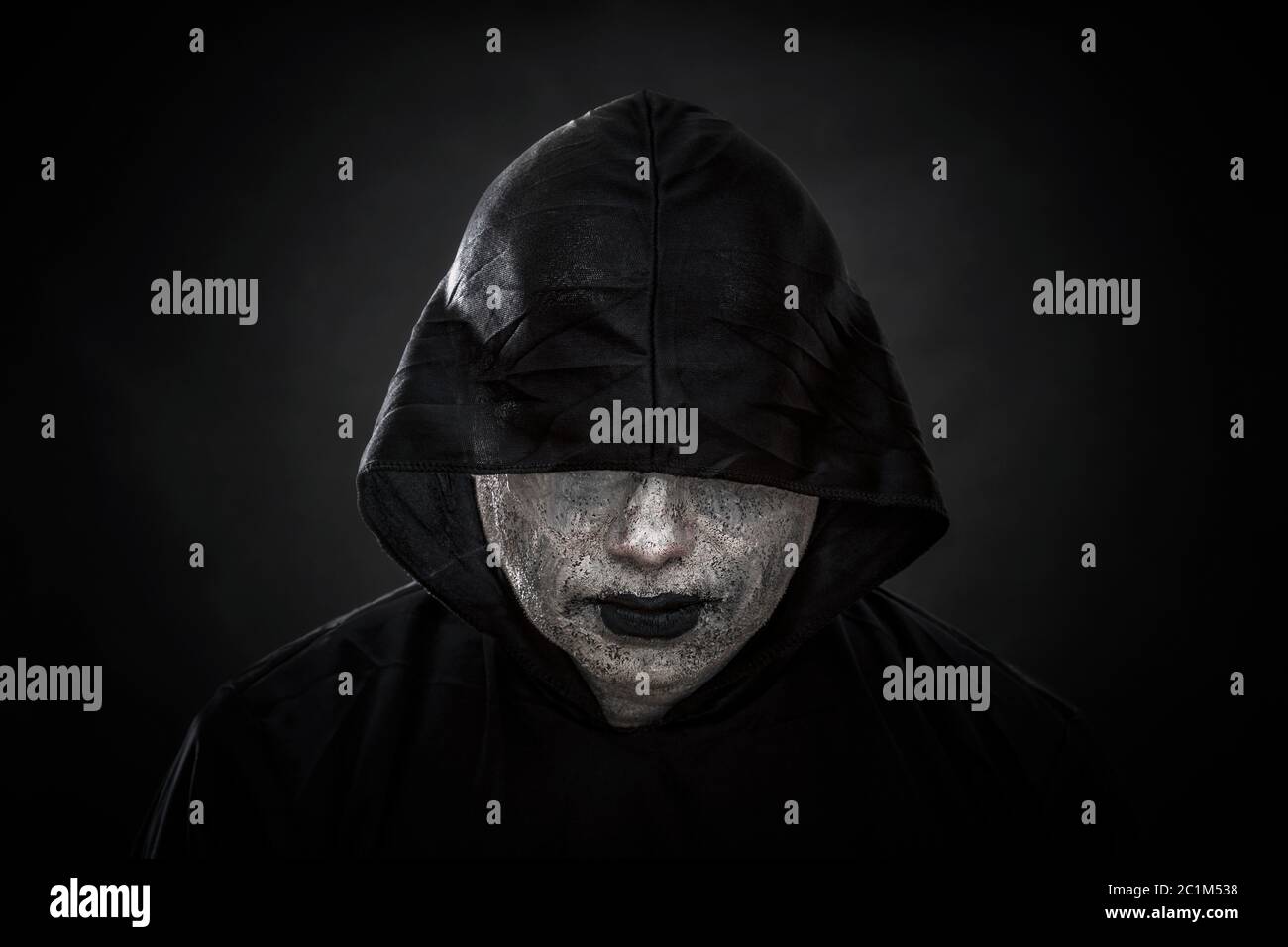 Scary figure in hooded cloak Stock Photo - Alamy