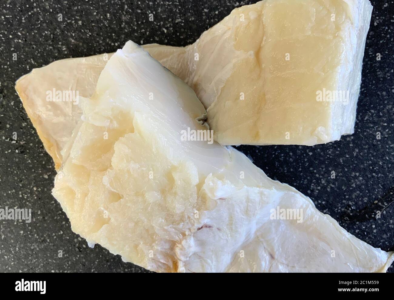 Two portions of cod fish ready for cooking after being rehydrated and