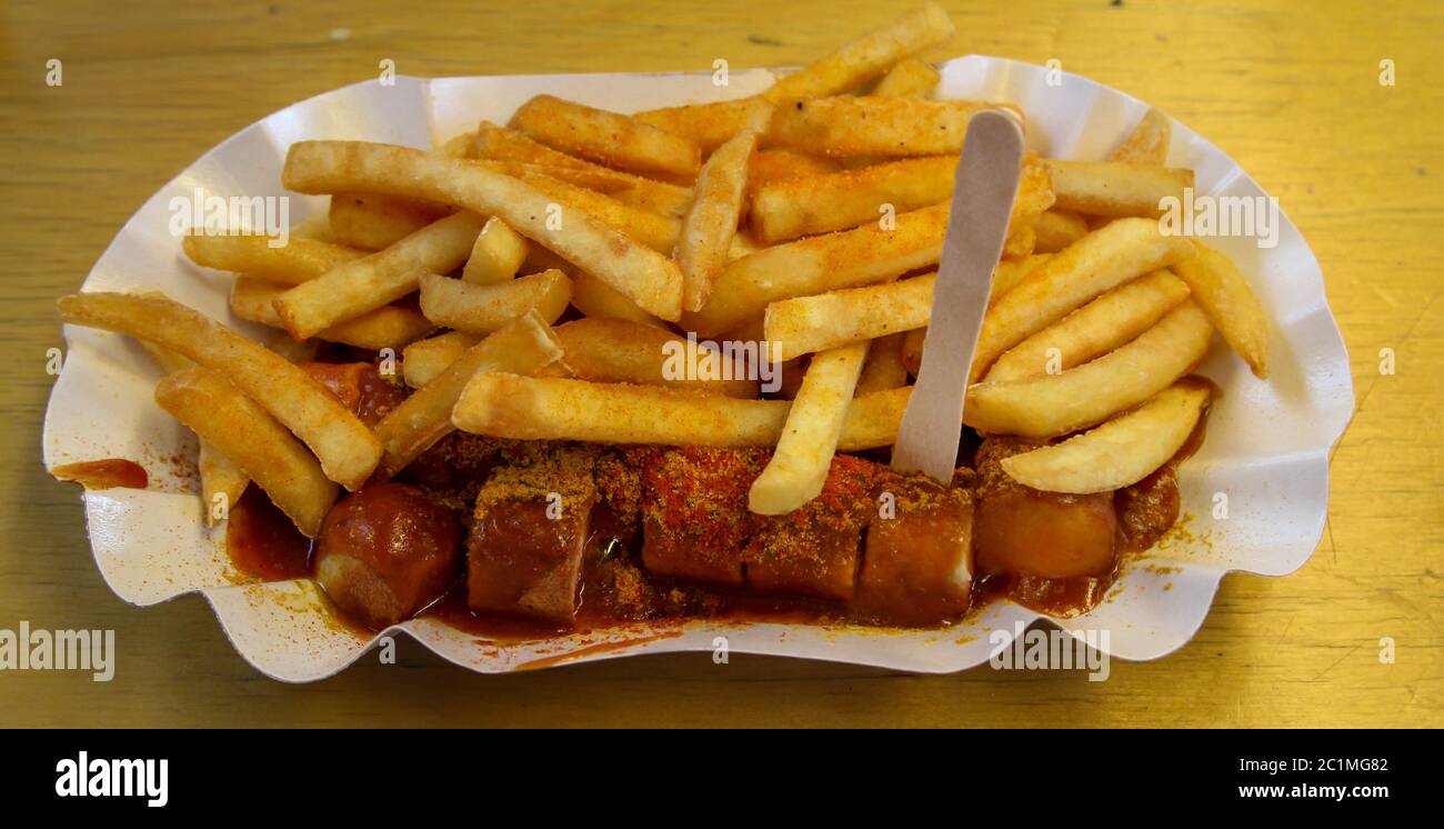 an original curry sausage with pommes Stock Photo
