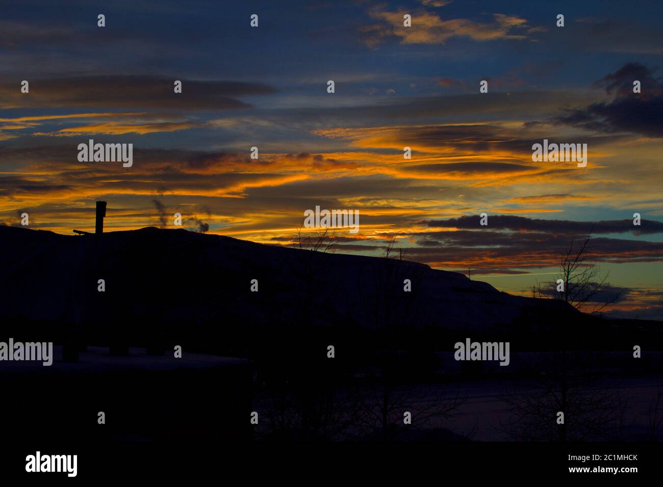 Silhouette of Kiruna Iron ore mine with yellowish brown twilight sky in the background just after sunset Stock Photo