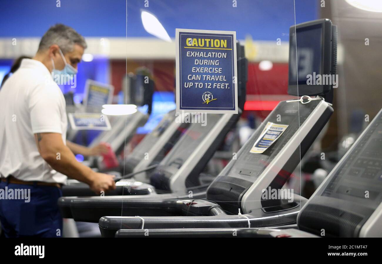 Maplewood United States 15th June Employee Matt Bohn Uses An Ultra Violet Light To Kill Bacteria On A Treadmill While Plexiglass Separates Machines At The Club Fitness Gym In Maplewood Missouri