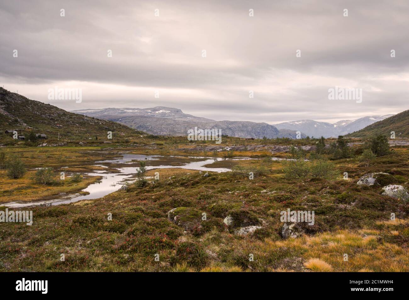 rugged wild mountain landscape in norway cloudy and calm river Stock Photo