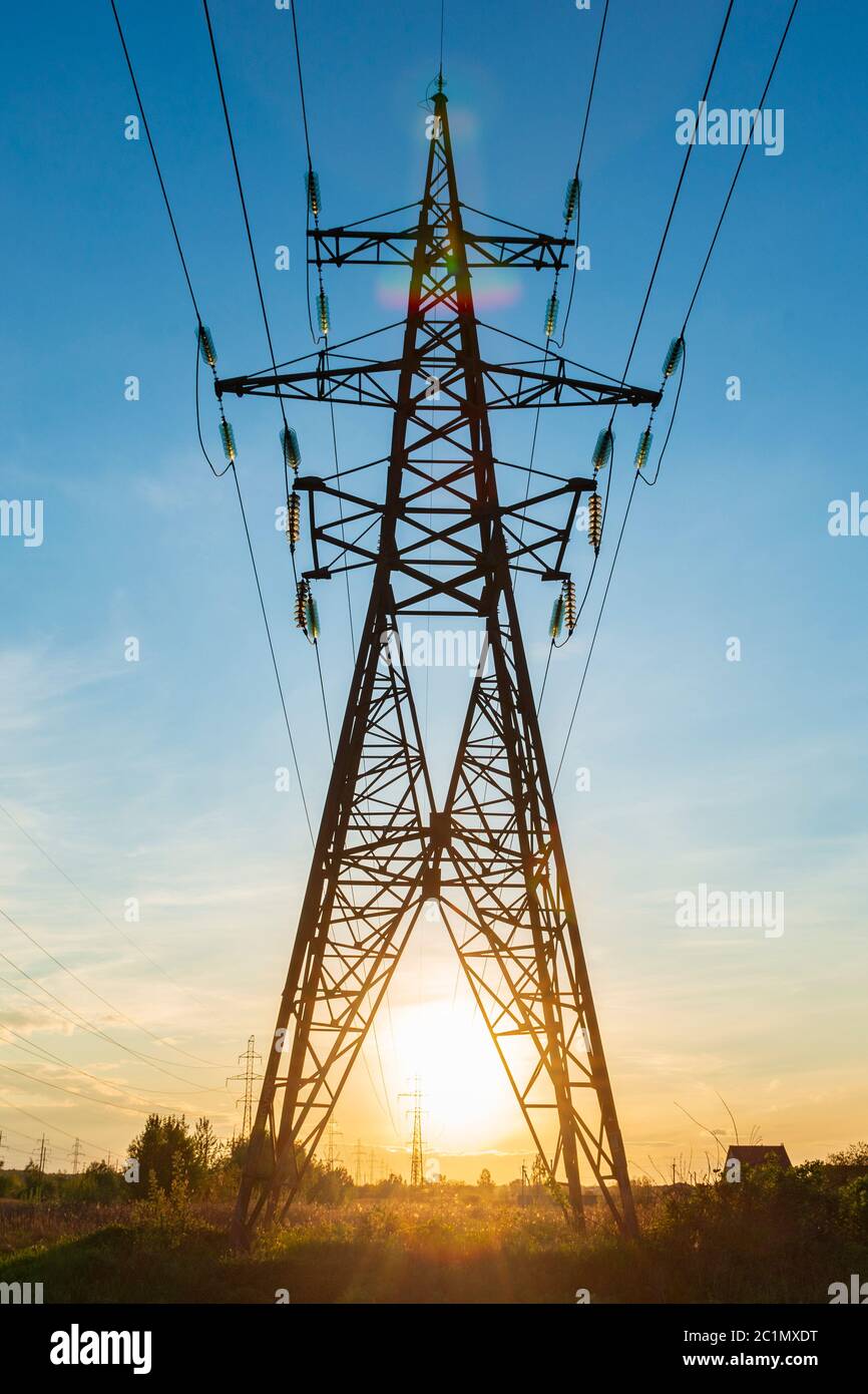 Power line support tower at the sunset. Energy distribution Stock Photo
