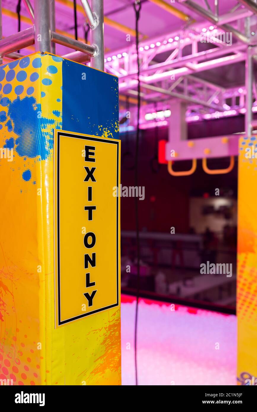 Exit only yellow sign in indoor amusement center Stock Photo