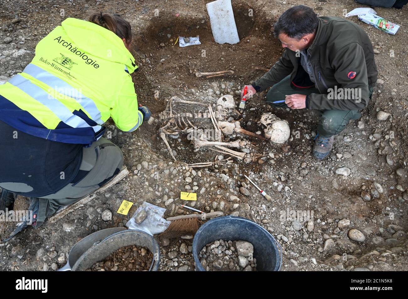 Allensbach, Germany. 04th June, 2020. District archaeologist and excavation director Jürgen Hald (r) and excavation technician Rebecca Letzing excavate parts of skeletons at the historical execution site not far from the Gnadensee (part of Lake Constance). Archaeologists have found the remains of a gallows, several skeletons and cremation pits there. (to dpa: 'Death on the gallows - archaeologists discover execution site at Lake Constance') Credit: Felix Kästle/dpa/Alamy Live News Stock Photo