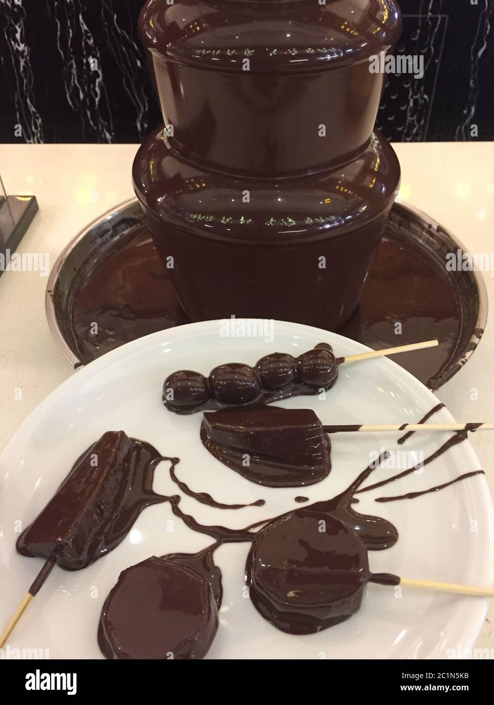 a chocolate fountain with fruits Stock Photo Alamy
