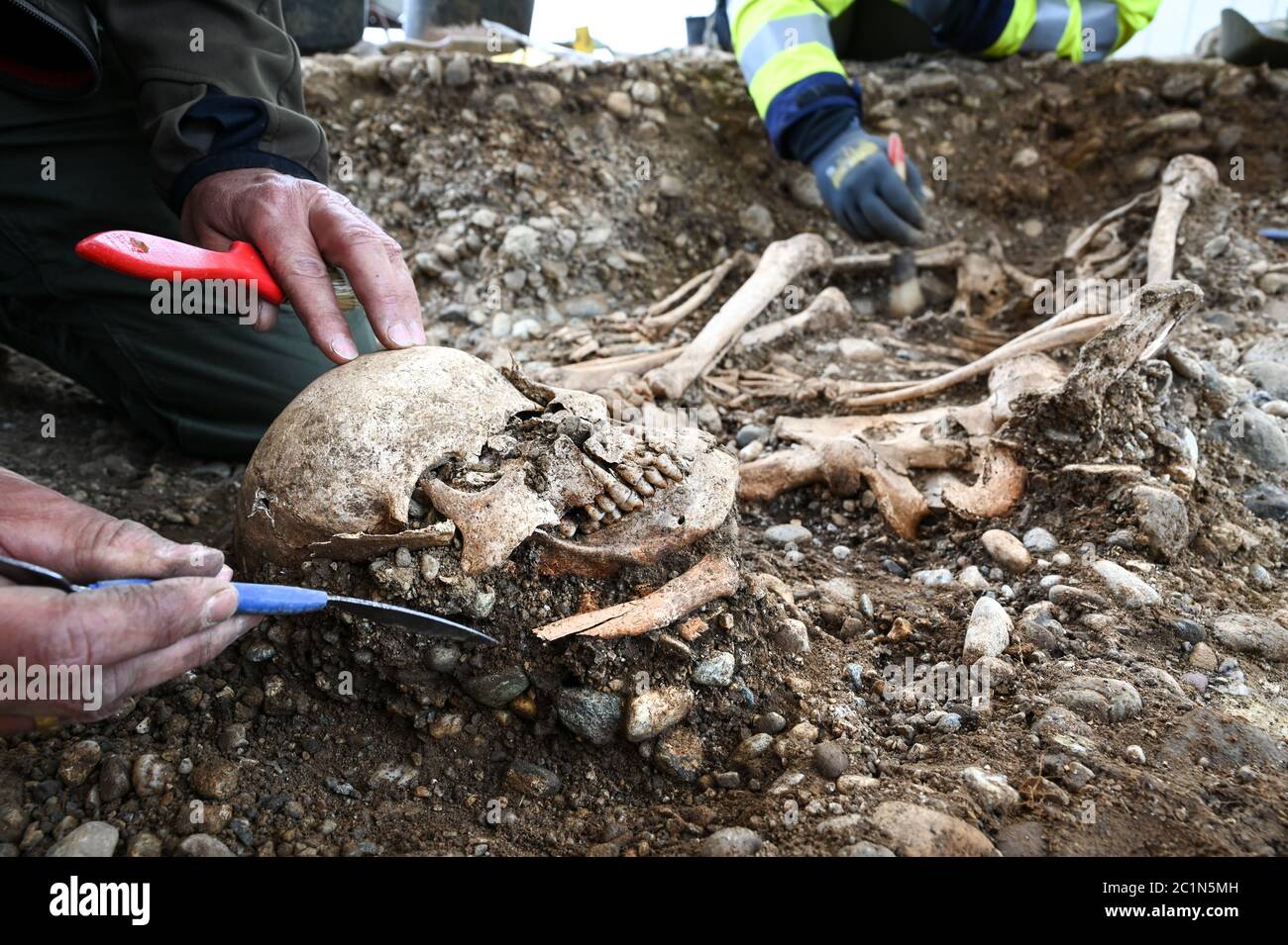 Allensbach, Germany. 04th June, 2020. District archaeologist and excavation director Jürgen Hald (l) and excavation technician Rebecca Letzing excavate parts of skeletons at the historical execution site not far from the Gnadensee (part of Lake Constance). Archaeologists have found the remains of a gallows, several skeletons and cremation pits there. (to dpa: 'Death on the gallows - archaeologists discover execution site at Lake Constance') Credit: Felix Kästle/dpa/Alamy Live News Stock Photo