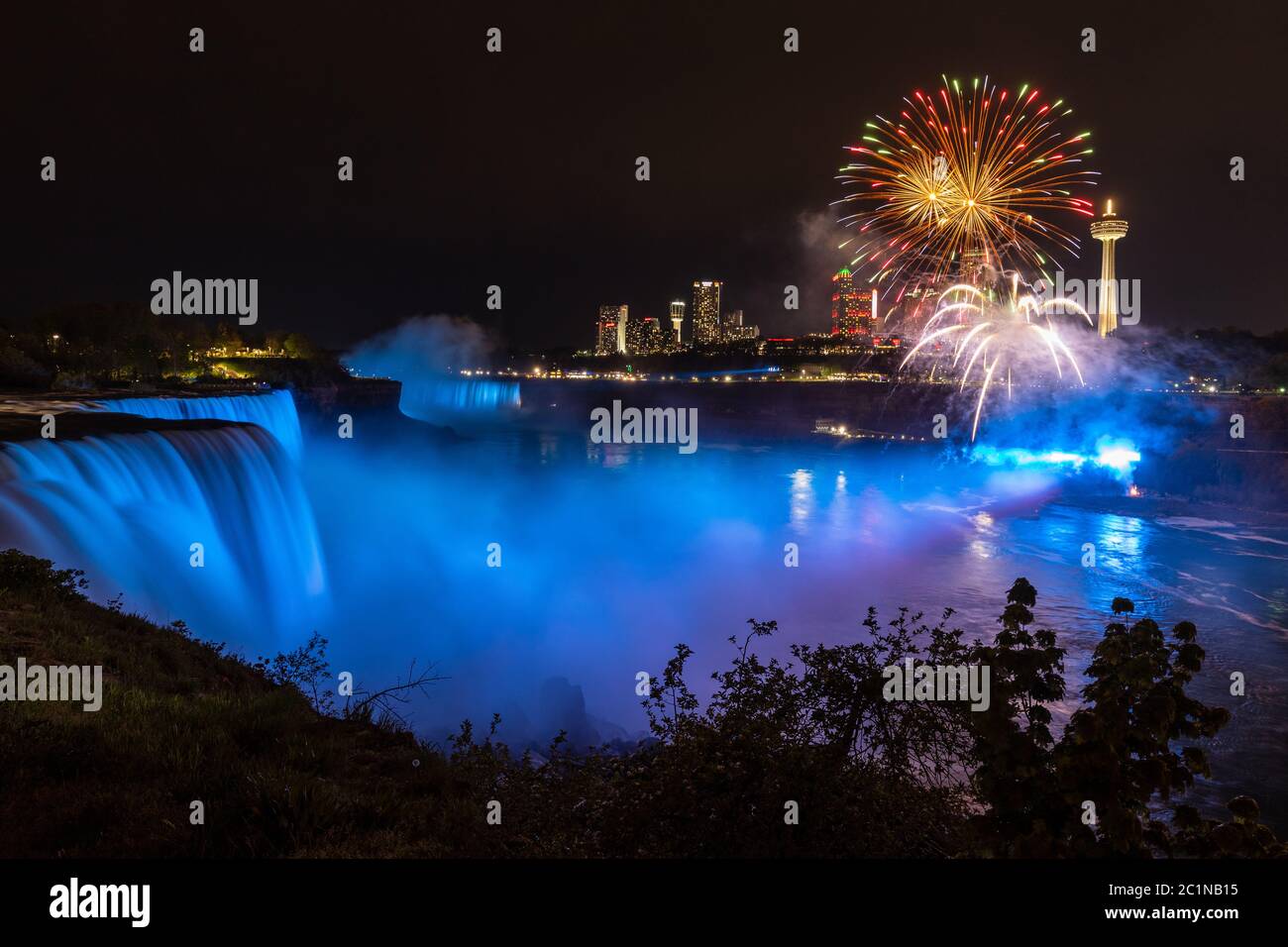 The Niagara falls with the skyline of Niagara Falls in Canada Stock