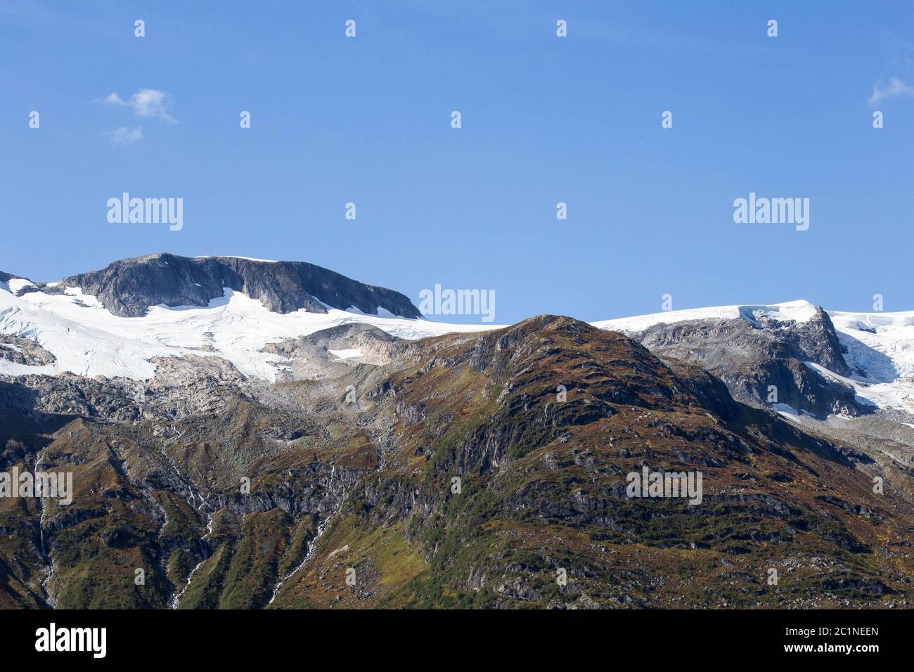 Closeup of beautiful snowy peaks of mountain. Winter travel vacation nature background. Mountains and blue sky. Snowscape, highl Stock Photo