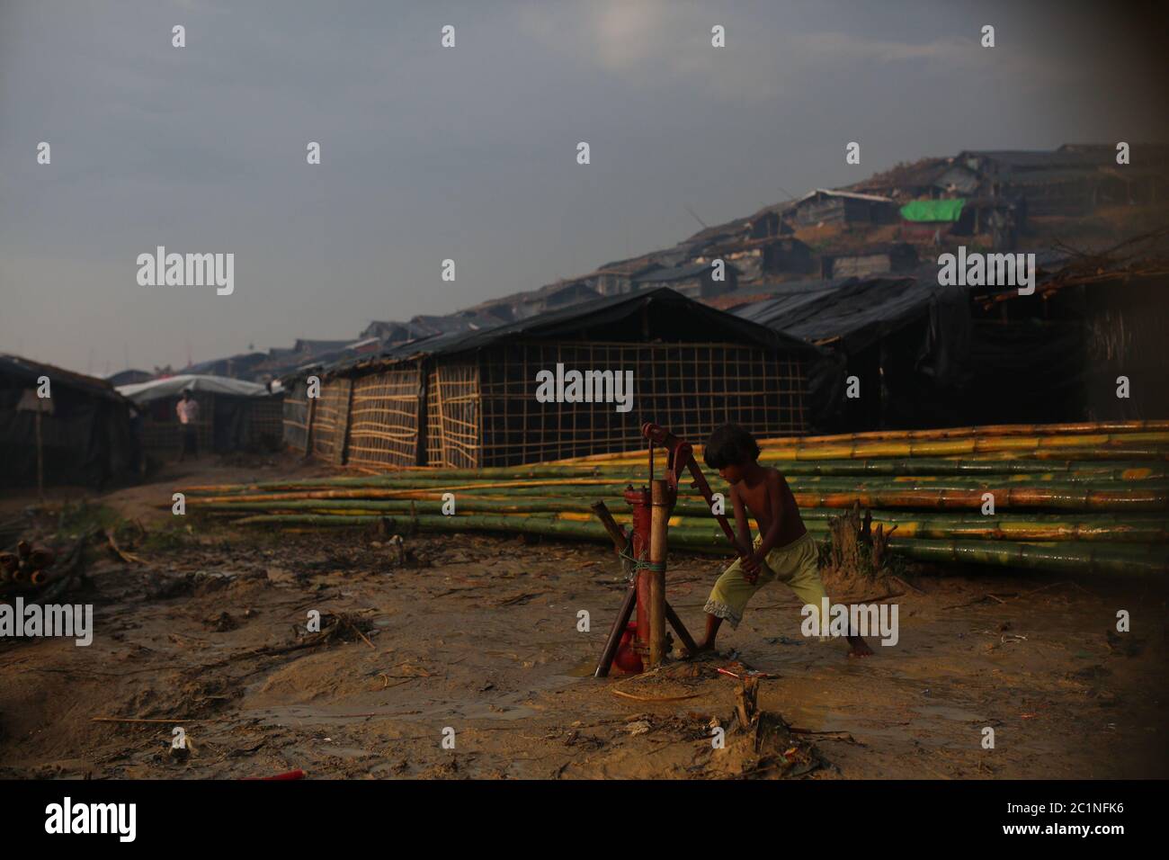 A Rohingya child collect drinkable water at Thangkhali refugee camp in ...