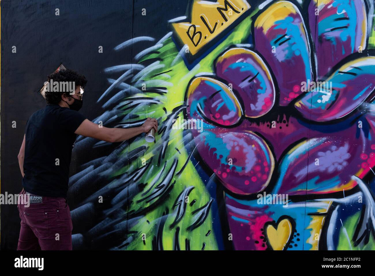 Brooklyn, United States Of America . 15th June, 2020. Calicho Arevalo paints his mural in Brooklyn, New York, on June 15, 2020. His mural is part of a series of paintings that have been going up on three walls on 4th Avenue between Sackett and Union Streets in support of the protests calling for racial justice. (Photo by Gabriele Holtermann/Sipa USA) Credit: Sipa USA/Alamy Live News Stock Photo