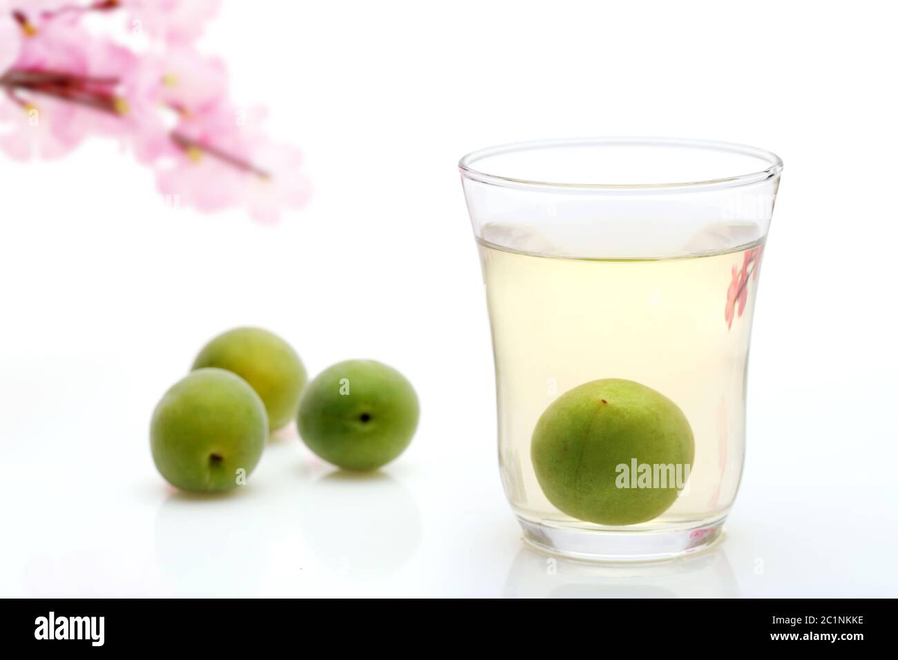 Japanese plum wine called umeshu on white background Stock Photo - Alamy