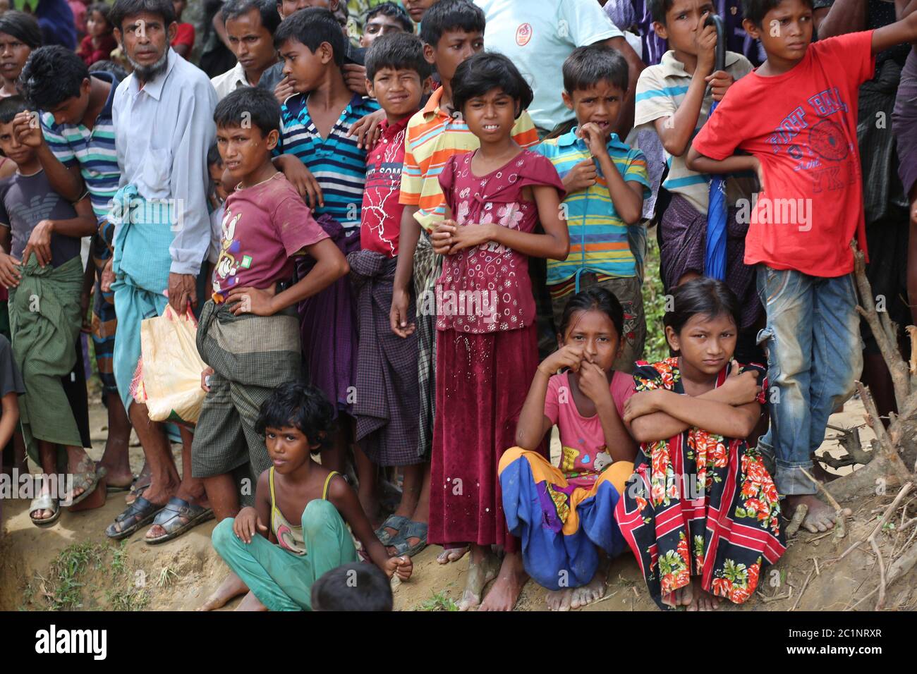 Rohingya people gather to collect food aid at Thangkhali refugee camp in Cox's Bazar, Bangladesh, Thursday, Oct. 5, 2017. Stock Photo
