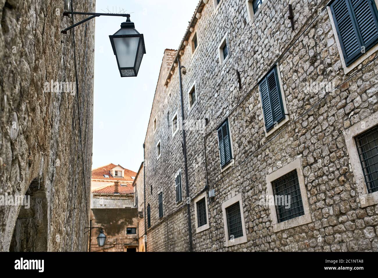 Old stone houses with windows with shutters and lanterns Stock Photo ...