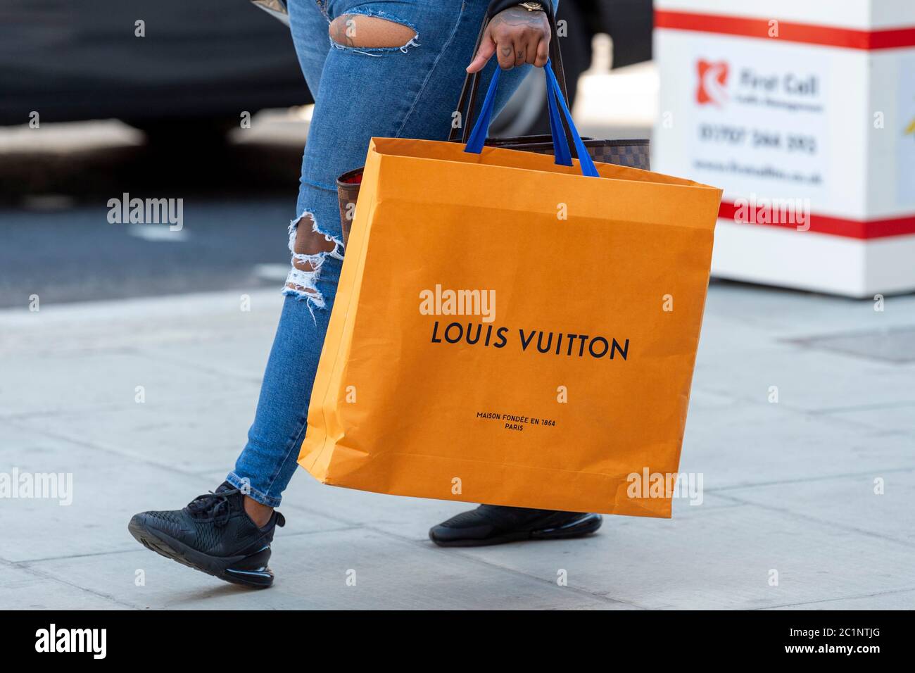 London, UK. 15th June, 2020. A shopper carries Louis Vuitton shopping bag on Oxford