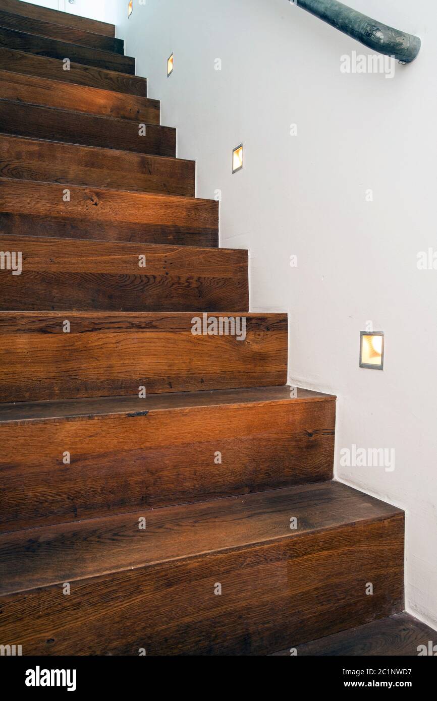 Wood stairs by night with led light in the white wall modern design Stock Photo