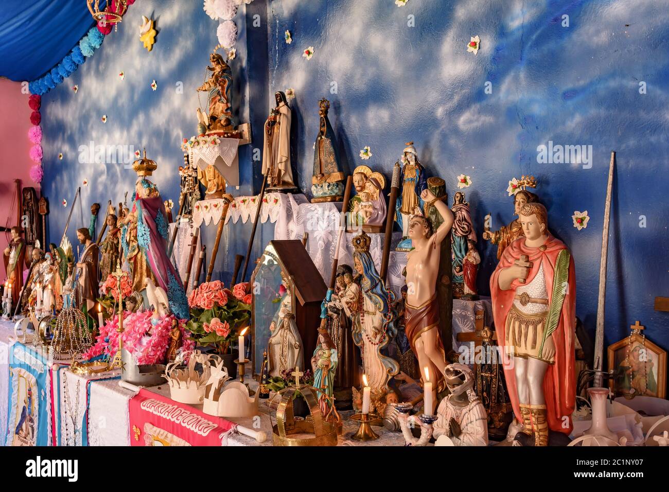 Religious altar with saints from diverse backgrounds represented Stock Photo