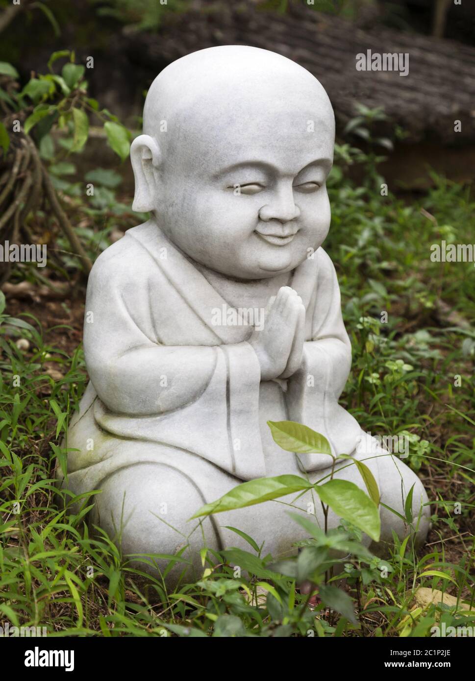 Small Buddha statue in a garden Stock Photo Alamy
