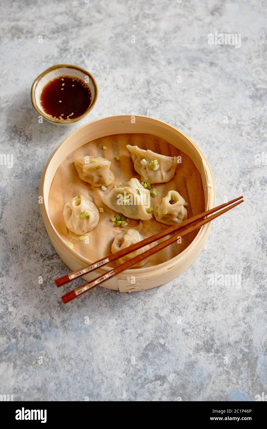 Delicious chinese dumplings served in wooden bamboo steamer Stock Photo