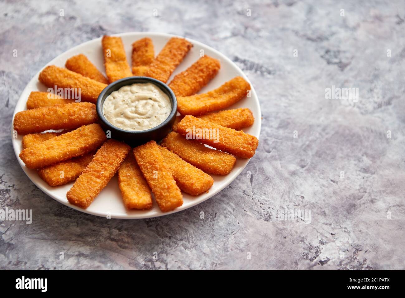 Crumbed fish sticks served with garlic dip sauce Stock Photo Alamy