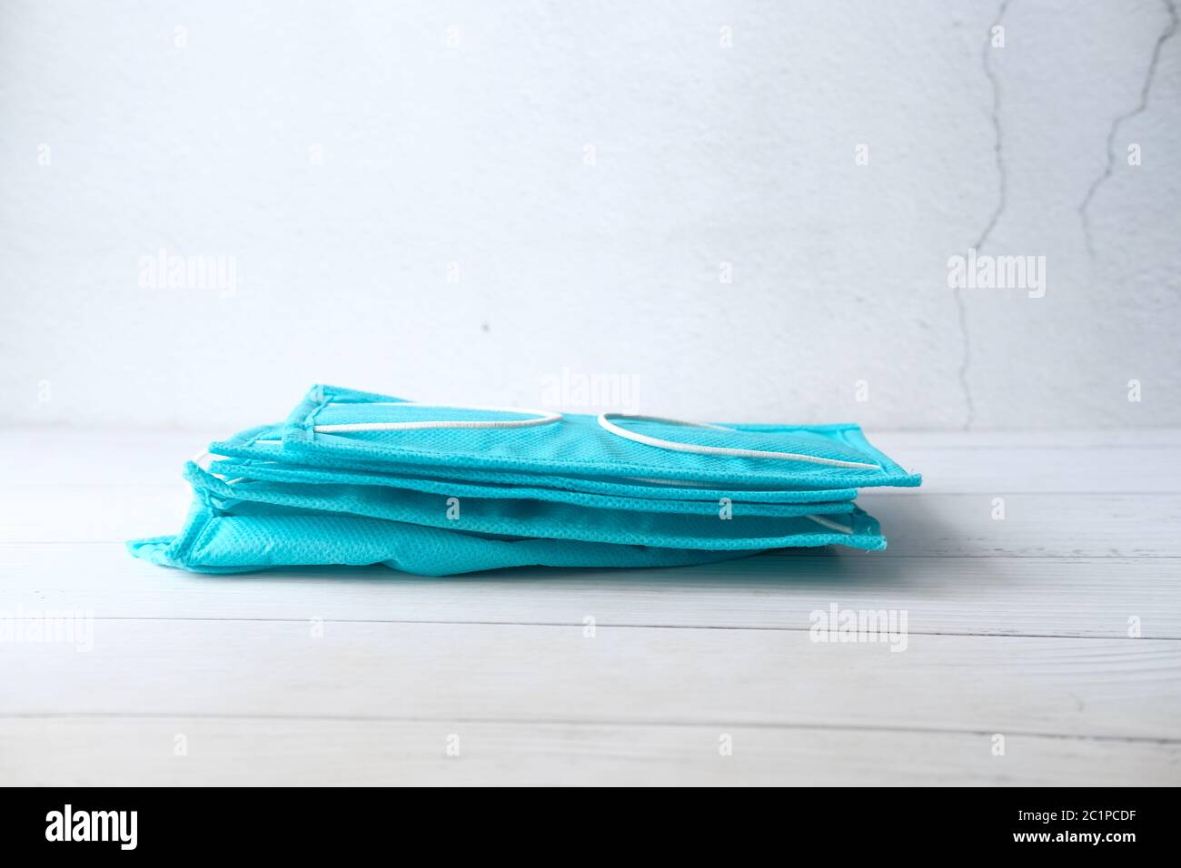 Surgical masks with rubber ear straps drop on gray background Stock Photo Alamy