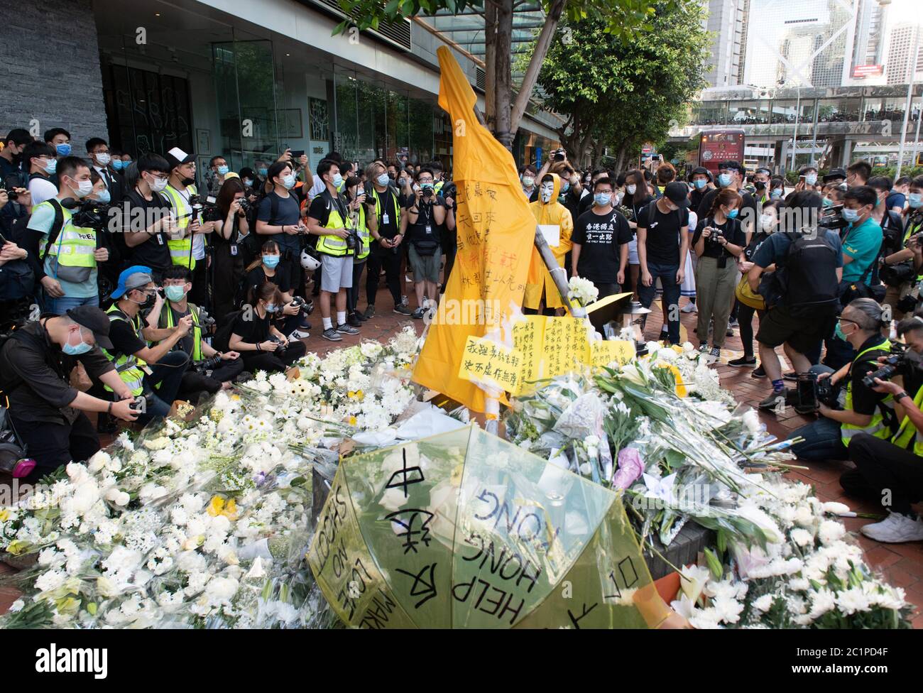 HONG KONG,HONG KONG SAR,CHINA: JUNE 15th 2020. Protesters take flowers to the site of Marco Leungs death at Pacific Place Mall in Admiralty Hong Kong. They are there to commemorate the first democracy protesters death on one year ago. Marco Leung fell to his death from scaffolding outside the building on 15th June 2019. He became known as the raincoat man.  Alamy Stock Image/Jayne Russell Stock Photo