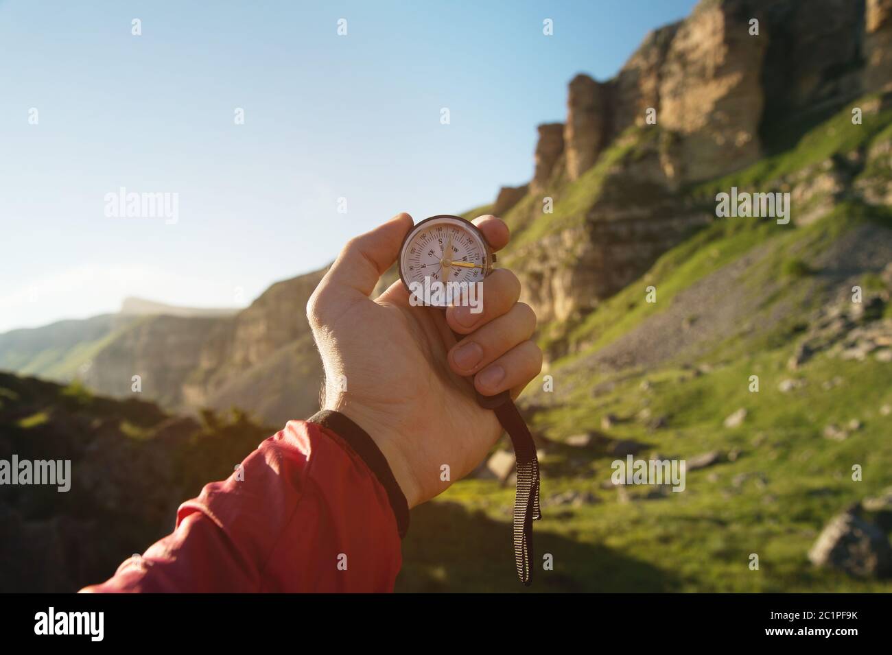 Man explorer searching direction with compass for map