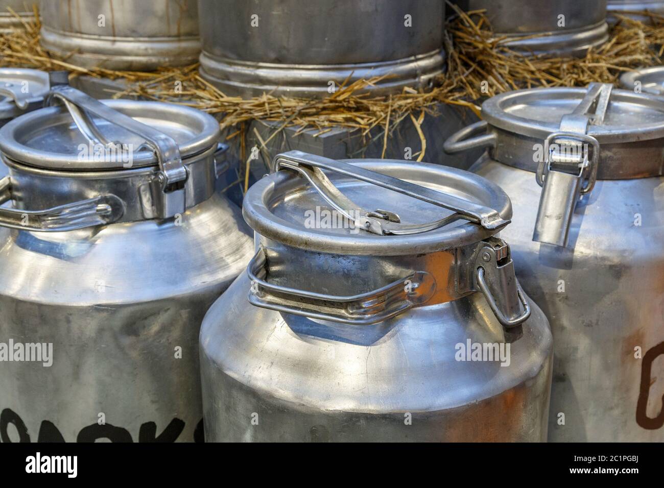 Traditional Milk Cans in front of a farm Stock Photo