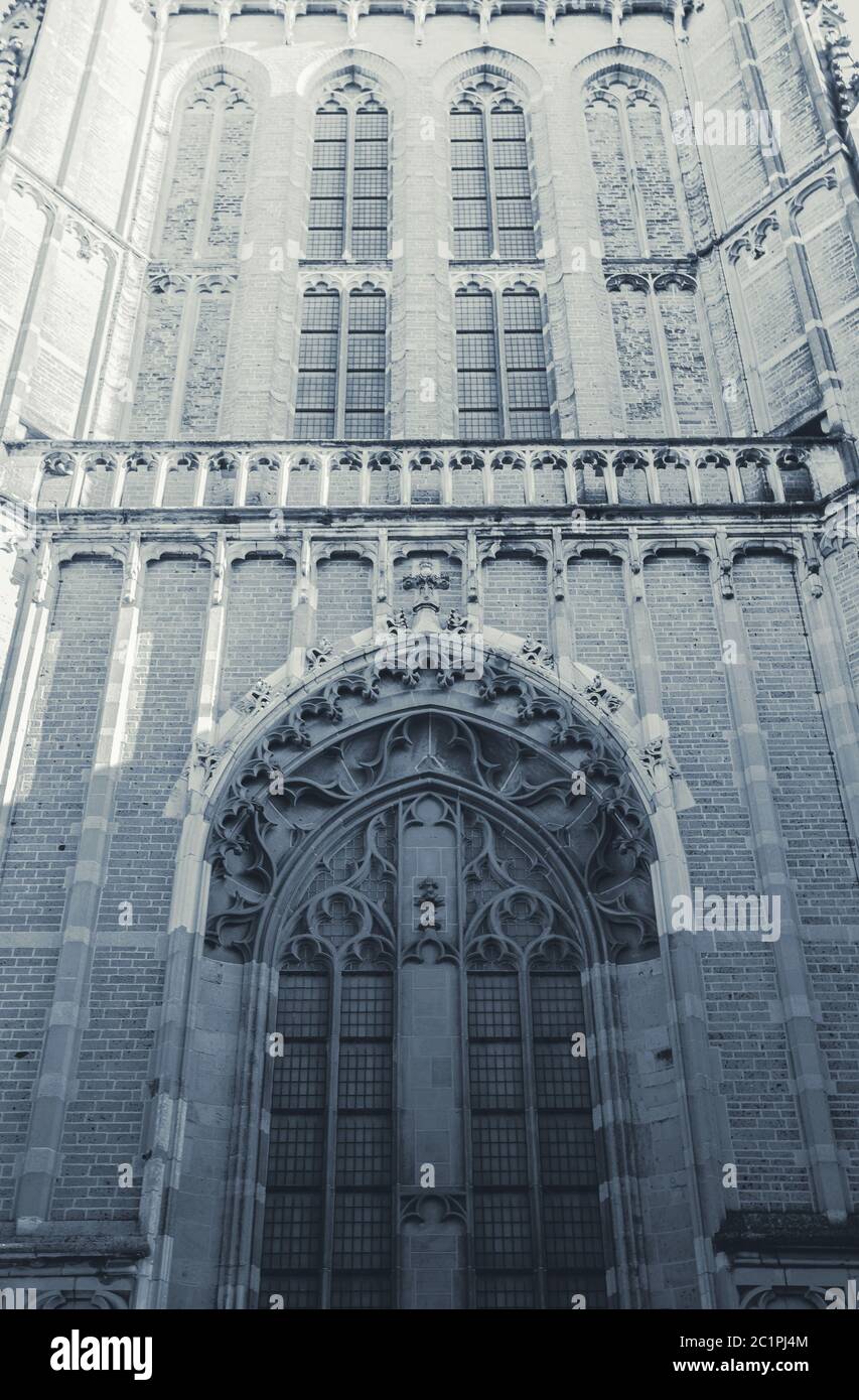 front view of a big church with a tower and clock close-up black and white Stock Photo