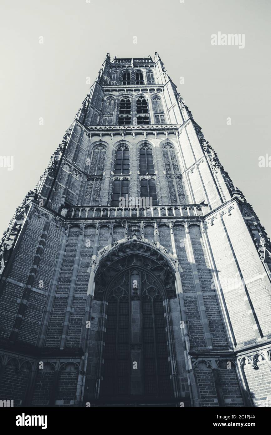 front view of a big church with a tower and clock close-up black and white Stock Photo