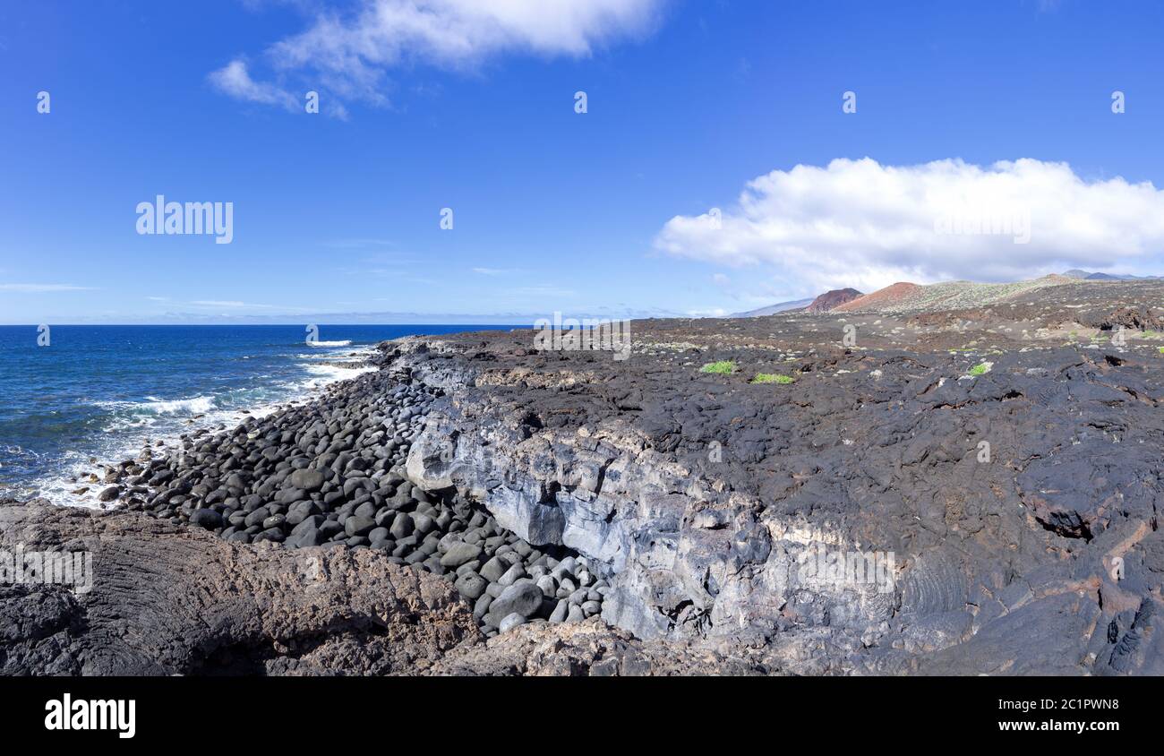 Solidified lava and big pebble stones on the south coast of El Hierro, Canary Islands, west of La Restinga Stock Photo