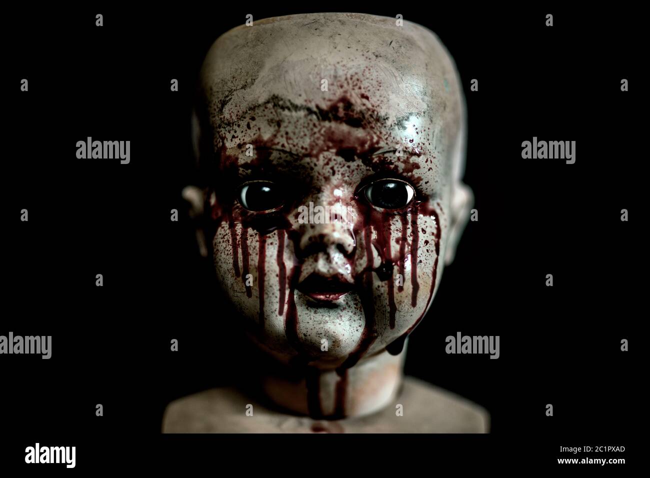 Creepy bloody doll in the dark Stock Photo