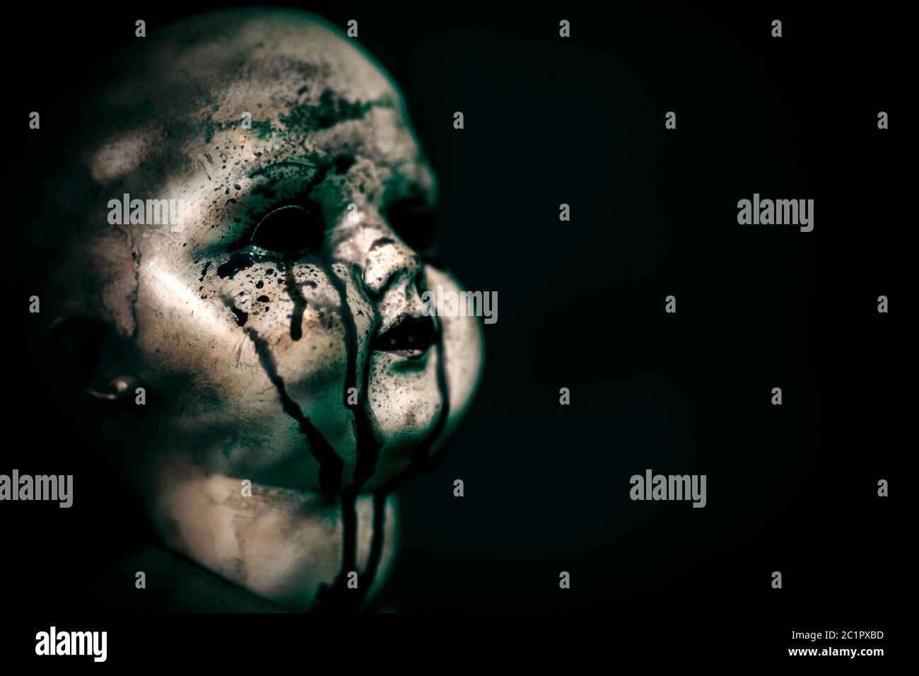 Creepy bloody doll in the dark Stock Photo