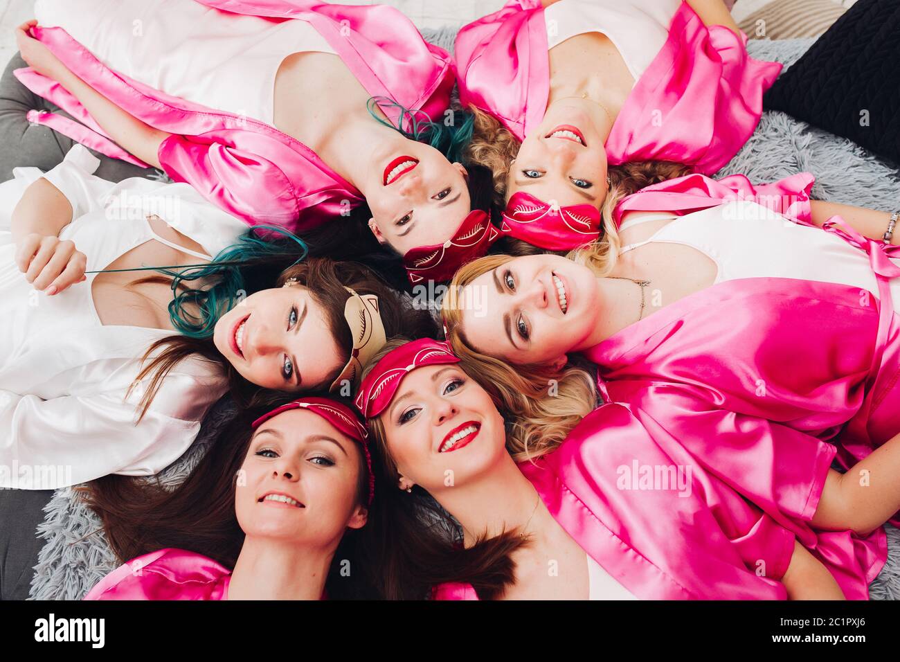 Portrait of beautiful girls in pink robes celebrating bridal shower. Stock Photo