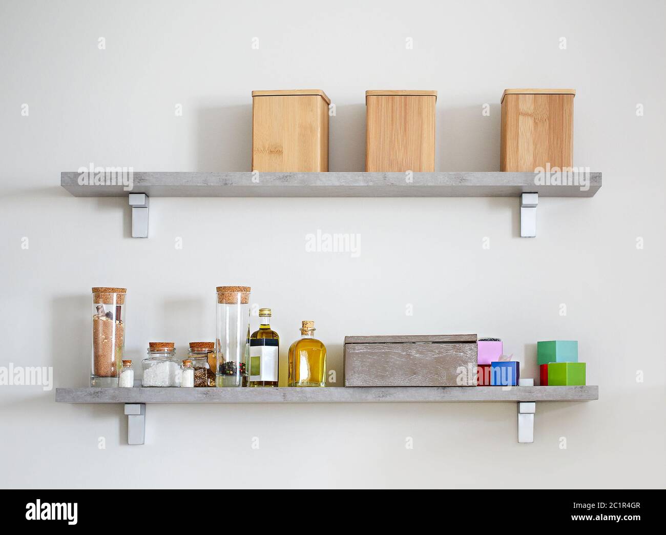 Arranged jars with various spices on kitchen shelves Stock Photo