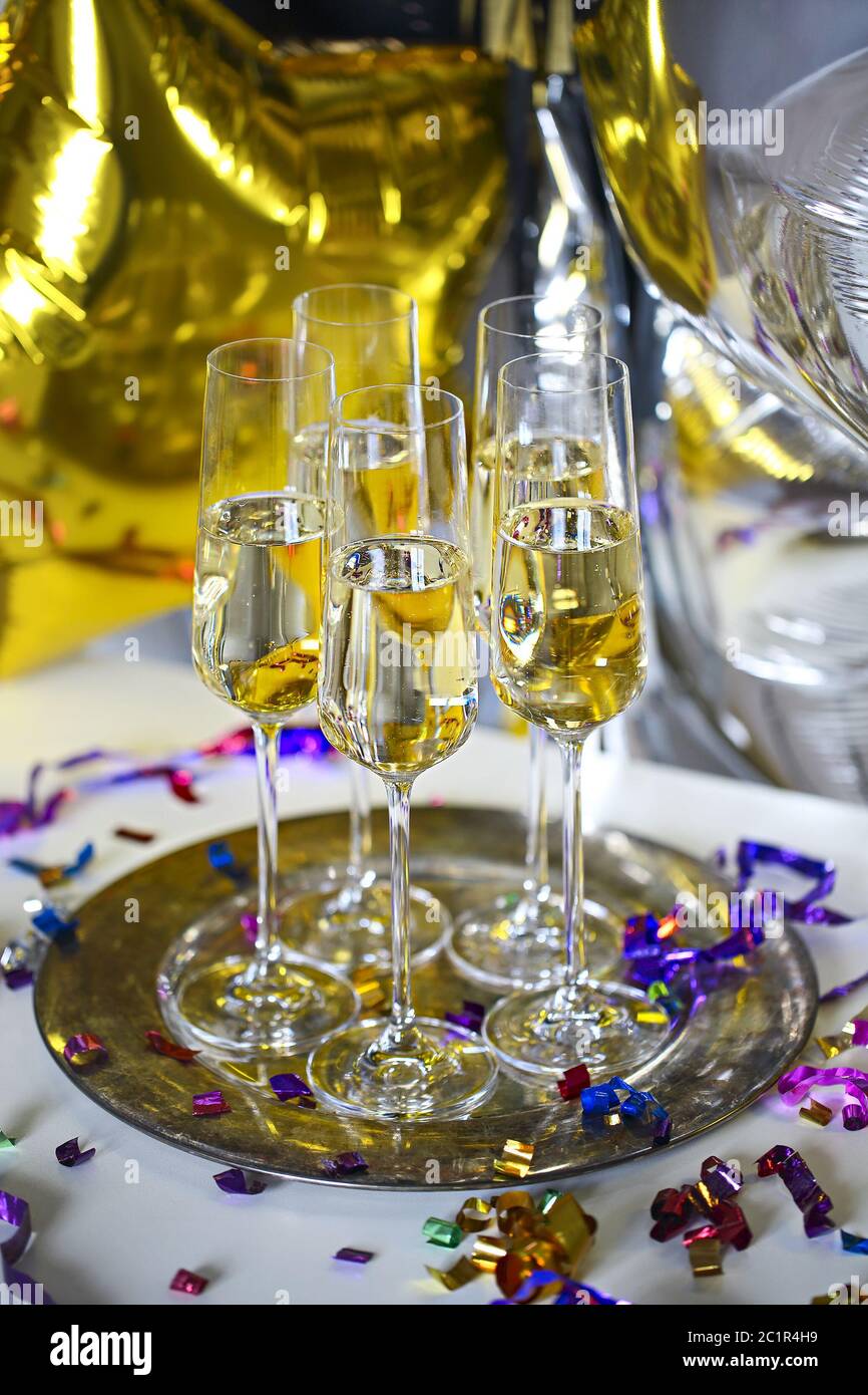 Close up of shiny glasses of champagne over party background Stock Photo