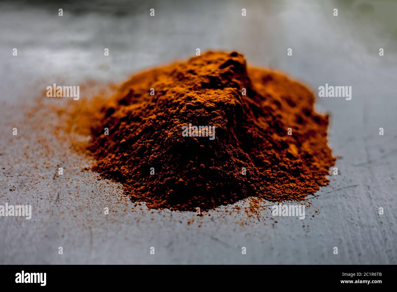 Shot of raw revand chini powder on a wooden surface. Shot in dark gothic colors. Stock Photo