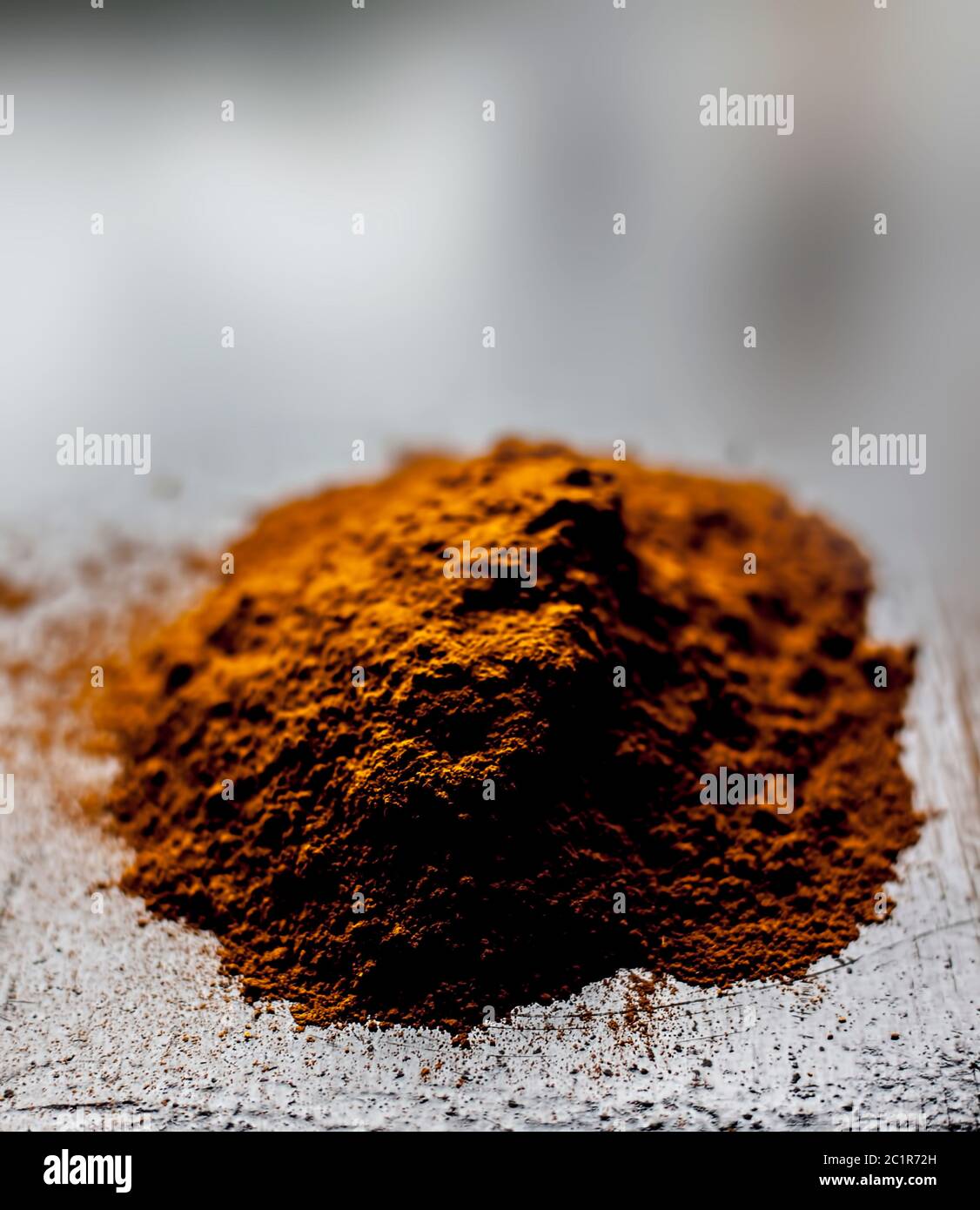 Shot of raw revand chini powder on a wooden surface. Shot in dark gothic colors. Stock Photo