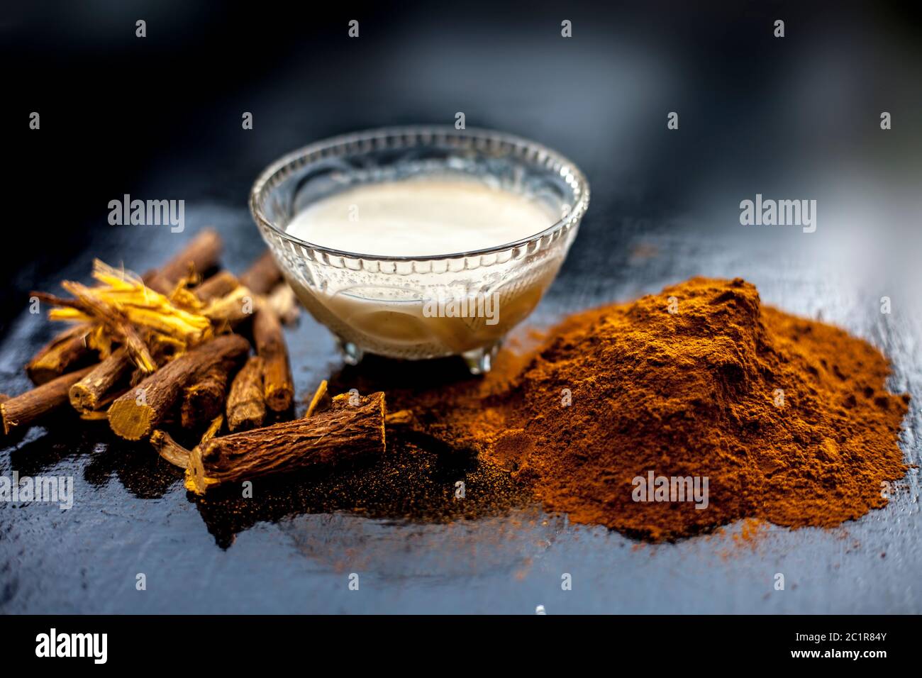 Face mask for Melasma consisting of Revand chini's powder, and milk. Shot of raw revand chini roots, powder, and milk. Stock Photo