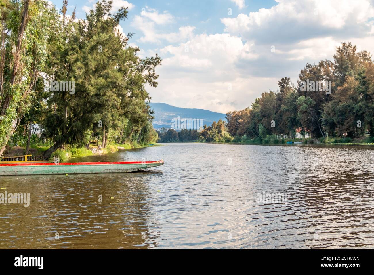 Panoramic view of Xochimilco channels or canals along the floating gardens or Chinampas in Mexico city at sunset with a couple of Trajinera boats in t Stock Photo