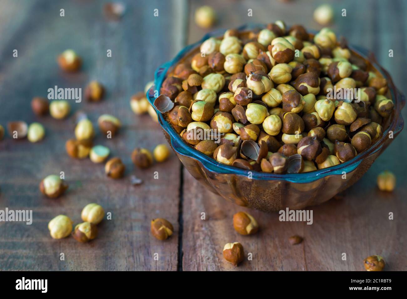 dry gram or chickpea on a bowl with wooden background Stock Photo