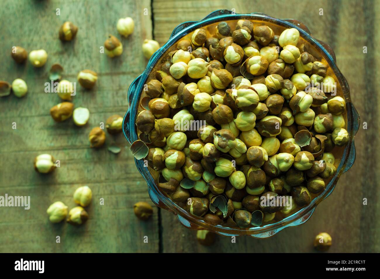 dry gram or chickpea on a bowl with wooden background Stock Photo