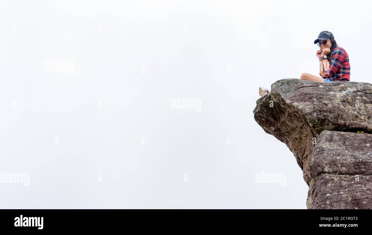 Girl sitting on edge cliff hi-res stock photography and images - Alamy
