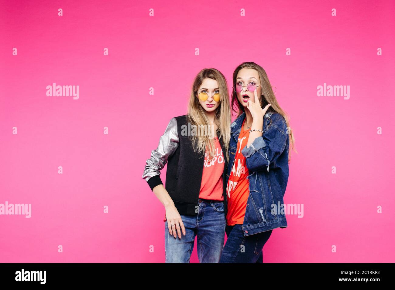 Two best girlriends shocked looking at camera Stock Photo - Alamy